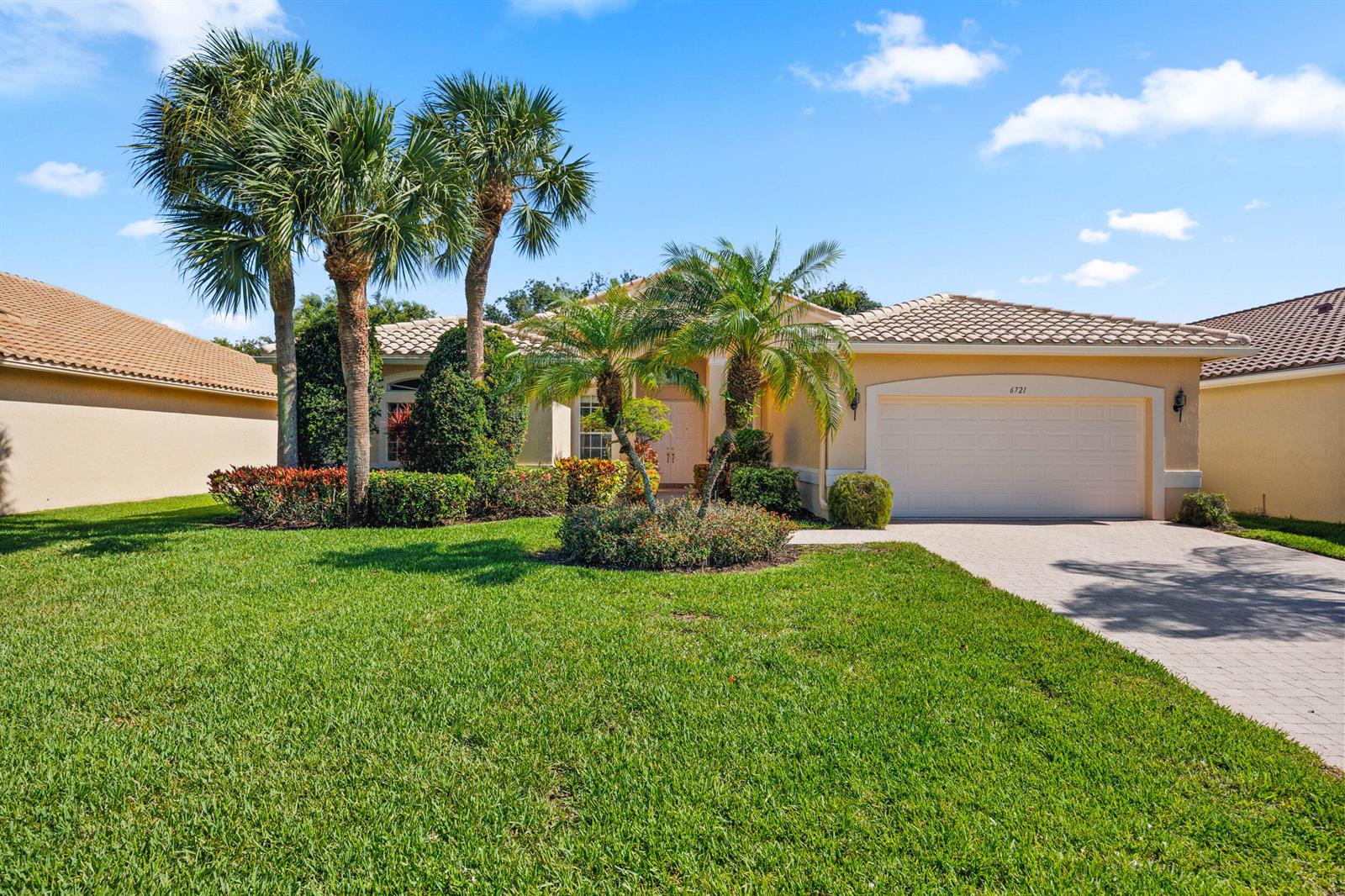 A single-story house with a beige exterior, a two-car garage, and palm trees in front — 6721 Arno Way, Boynton Beach FL 33472, BOYNTON BEACH, FL