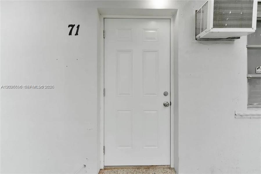 A white exterior door with the number 71 on the wall beside it — 69 NW 5th St, Homestead FL 33030, HOMESTEAD, FL
