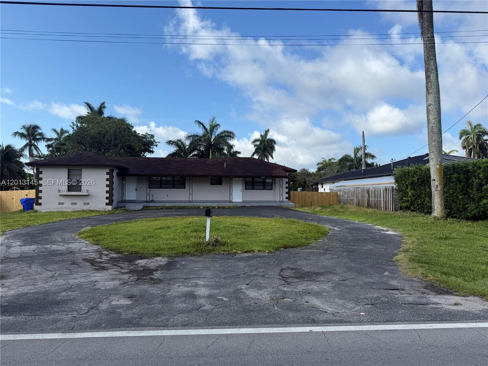 A single-story house with a circular driveway and a central lawn area — 2830 Johnson St # 1, Hollywood FL 33020, HOLLYWOOD, FL