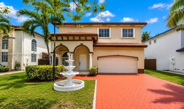 A two-story house with a white fountain in the front yard and a red driveway — 1308 SW 154th Ave, Miami FL 33194, MIAMI, FL