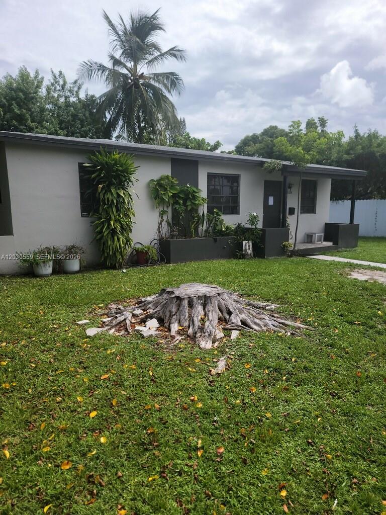 A single-story house with a large tree stump in the front yard — 1820 NW 127th St # 1820, Miami FL 33167, MIAMI, FL