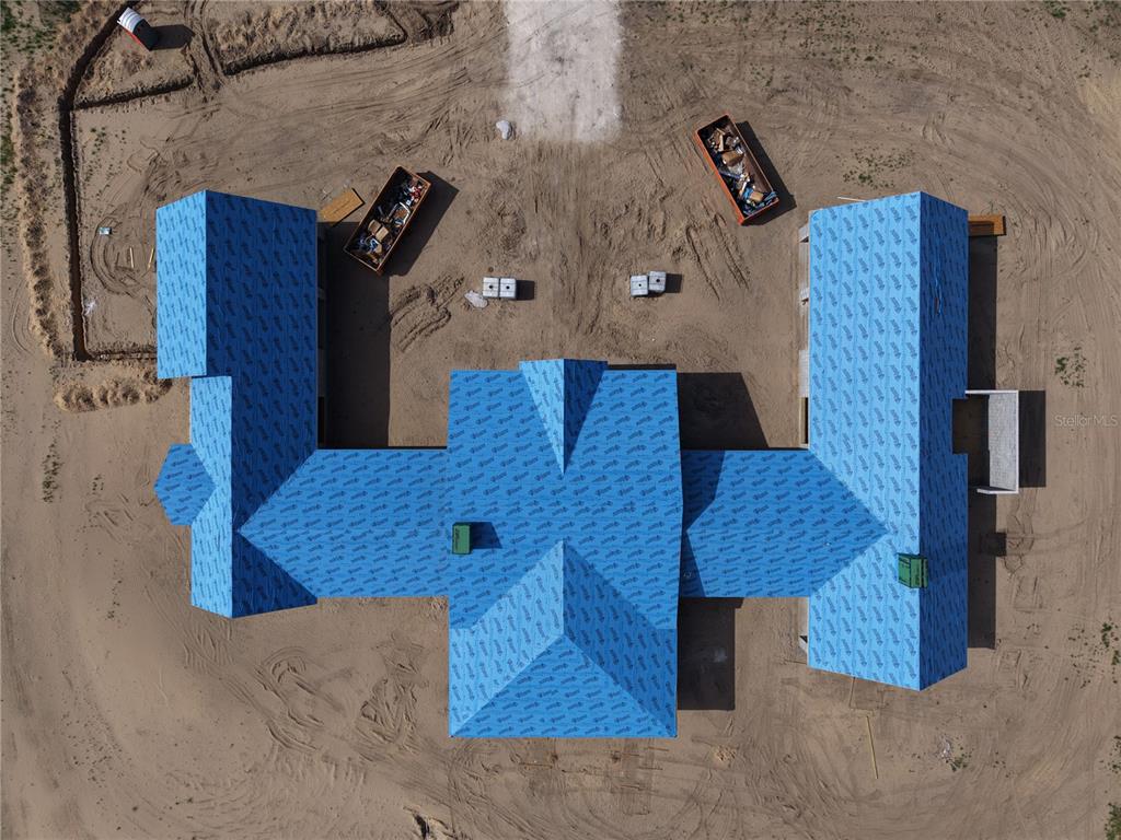 An aerial view of a modern farmhouse under construction on a large rural lot — 14951 SE 60TH STREET, MORRISTON, FL