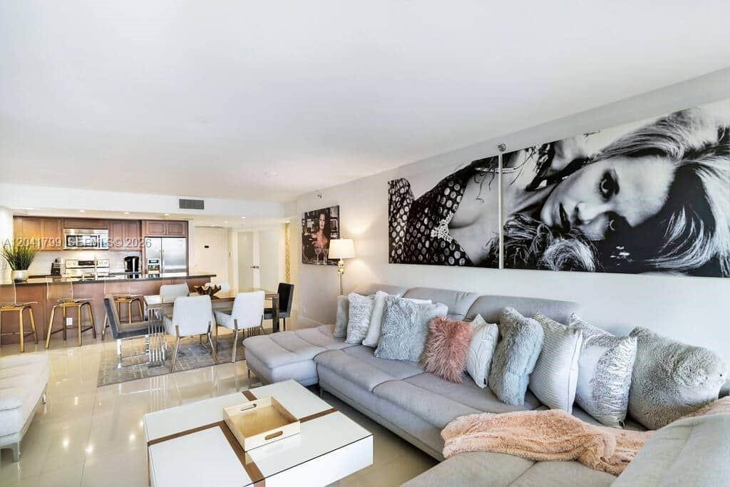 A living room features a large gray sectional sofa, a white coffee table, and kitchen — 1717 N Bayshore Dr # 2056, Miami FL 33132, MIAMI, FL