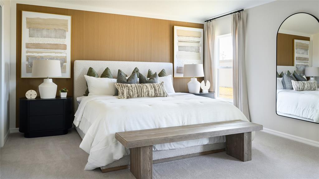 A bedroom features a textured wood-paneled accent wall, a white bed, and an arched mirror — 33619 NOBLE CREEK PLACE, DADE CITY, FL