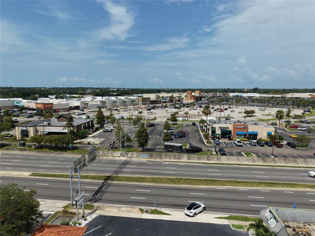 An aerial view shows a commercial shopping center with a large parking lot and highway — 3563 CYPRESS TERRACE N, PINELLAS PARK, FL