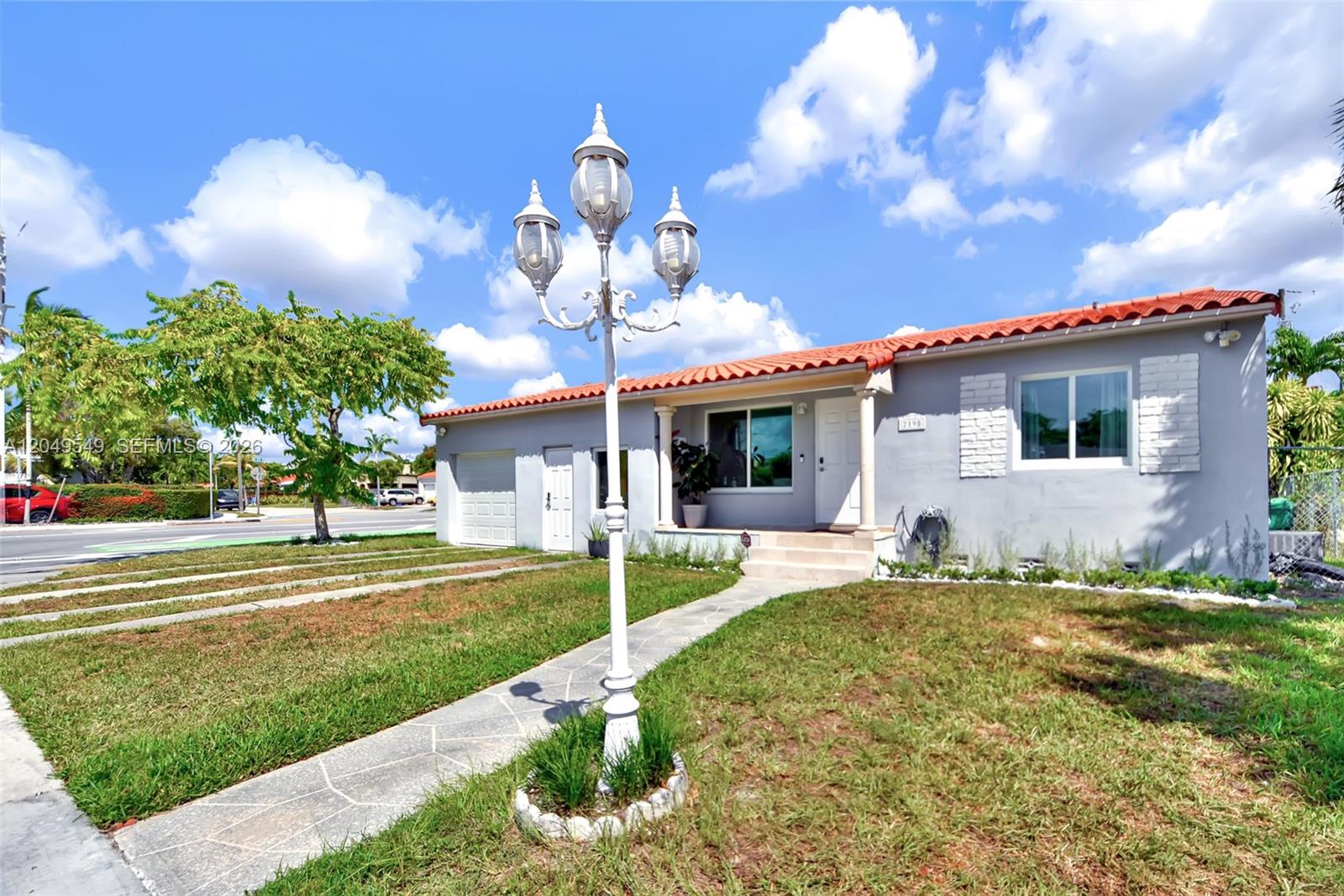 A single-story house with a gray exterior, red tile roof, and a decorative lamp post — 2195 SW 25th Ter, Miami FL 33133, MIAMI, FL