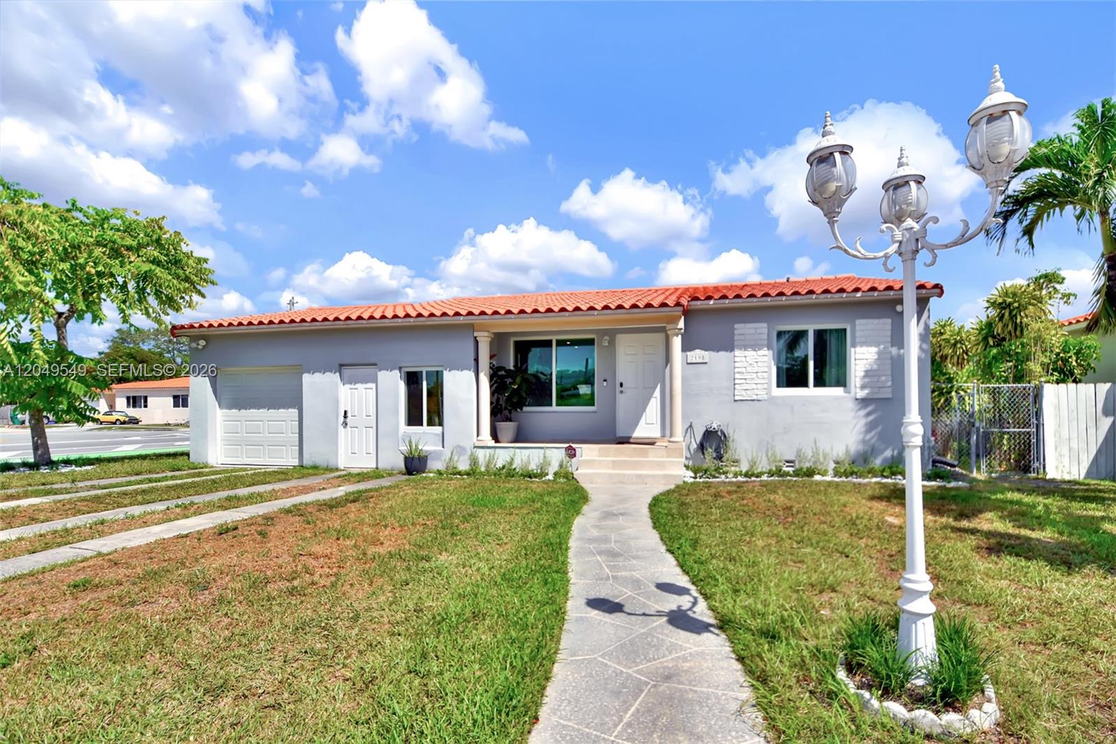 A single-story house with a gray exterior, red tile roof, and a front walkway — 2195 SW 25th Ter, Miami FL 33133, MIAMI, FL