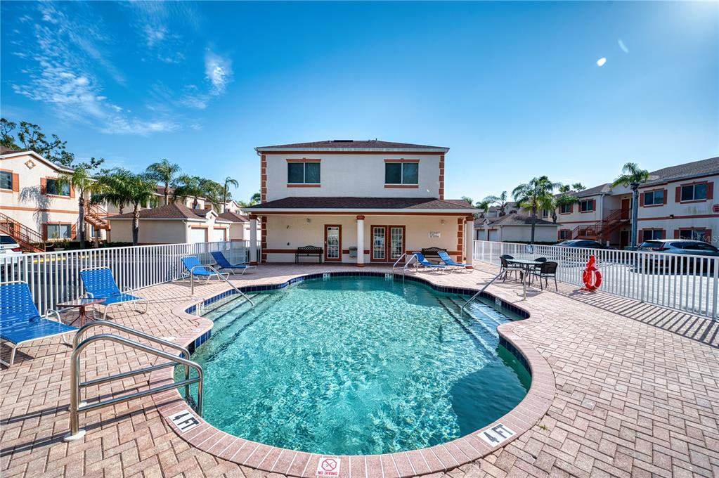 A kitchen features granite countertops, white cabinets, a double sink, and a breakfast nook area — 3980 MEDITERRANEA CIRCLE UNIT 522, SARASOTA, FL