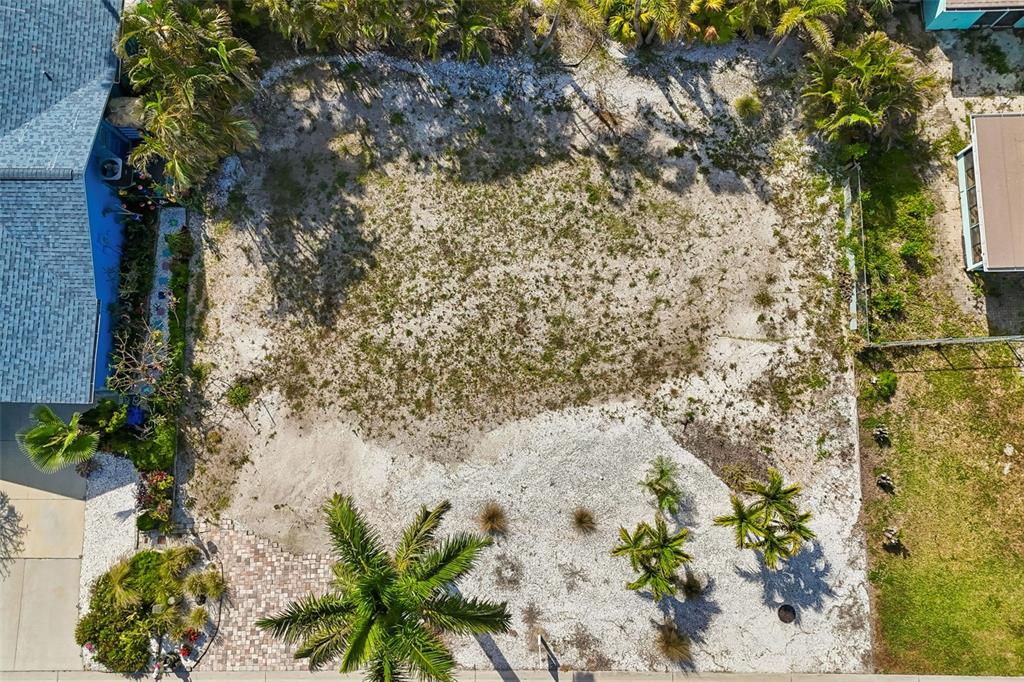 An aerial view shows a vacant, sandy residential lot with some palm trees and landscaping — 211 176TH TERRACE DRIVE E, REDINGTON SHORES, FL