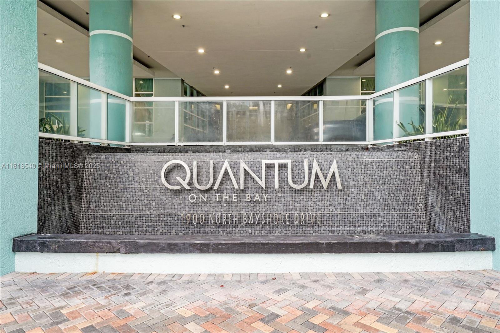 The exterior entrance features a tiled water feature with the building name and address — 1900 N Bayshore Dr # 1411, Miami FL 33132, MIAMI, FL