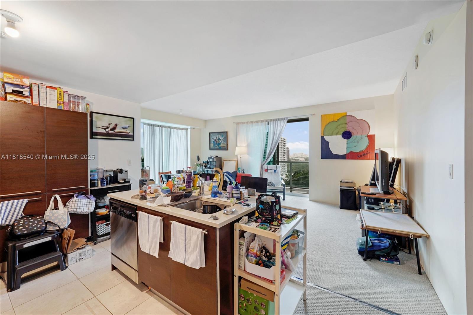 An open-concept kitchen and living area features a central island, tile flooring, and balcony access — 1900 N Bayshore Dr # 1411, Miami FL 33132, MIAMI, FL