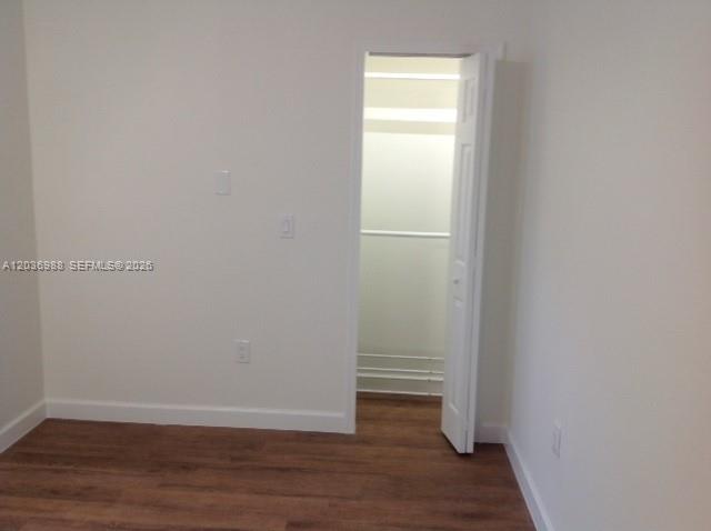 An empty room with white walls, wood-look flooring, and an open closet door — 3350 SW 3rd St, Miami FL 33135, MIAMI, FL