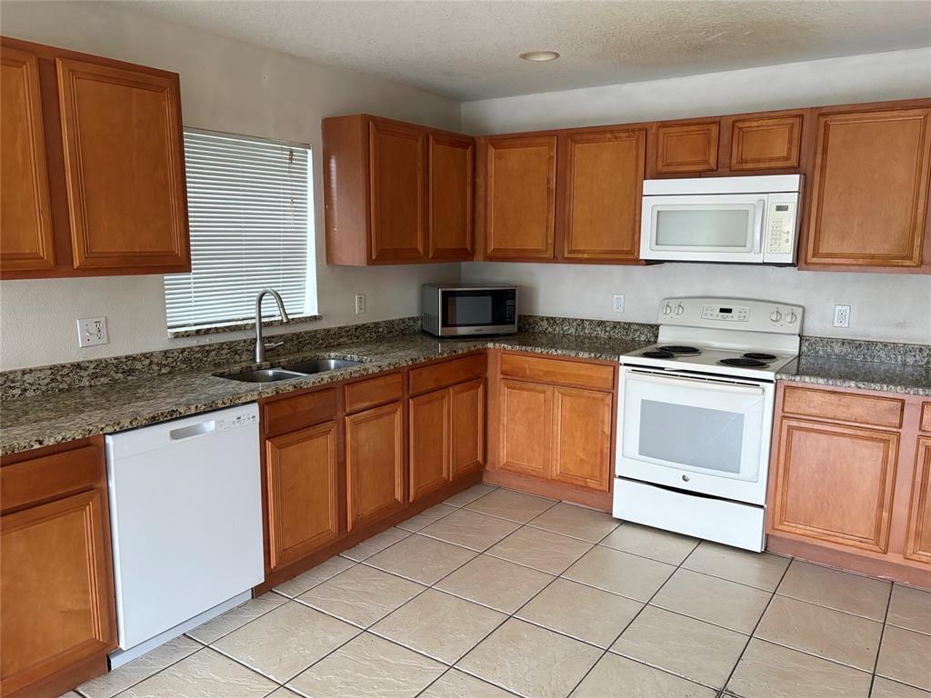 An empty bedroom features light-colored walls, wood-look flooring, and a white closet door — 15628 PERDIDO DRIVE, ORLANDO, FL