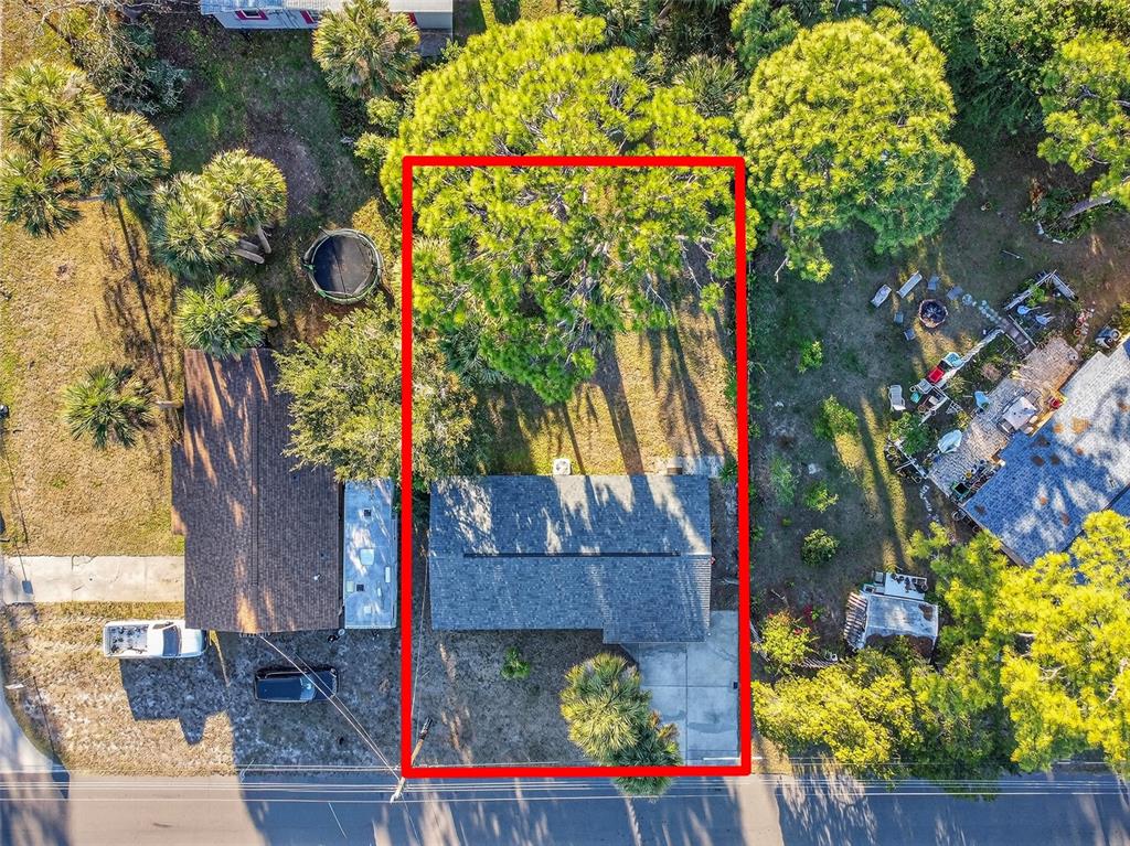 An aerial view shows a single-story house with a gray roof on a rectangular lot — 1806 JAMES STREET, SOUTH DAYTONA, FL