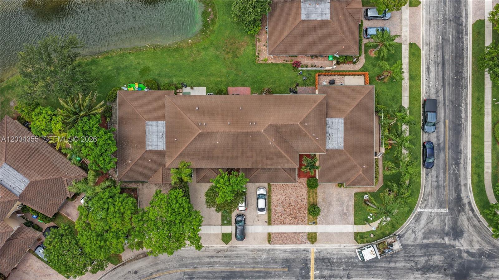 An aerial view shows a residential building with a brown tiled roof and paved driveway — 8964 NW 53rd Ct, Sunrise FL 33351, SUNRISE, FL
