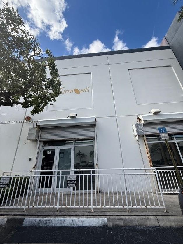 The exterior of a commercial building features two storefront entrances with roll-down security shutters — 7620 NW 25th St # 5, Miami FL 33122, MIAMI, FL