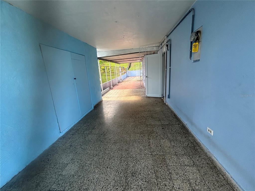 A covered patio with light blue walls, a speckled tile floor, and an open exterior view — 2 CALLE 2 VILLA RICA, BAYAMON, PR