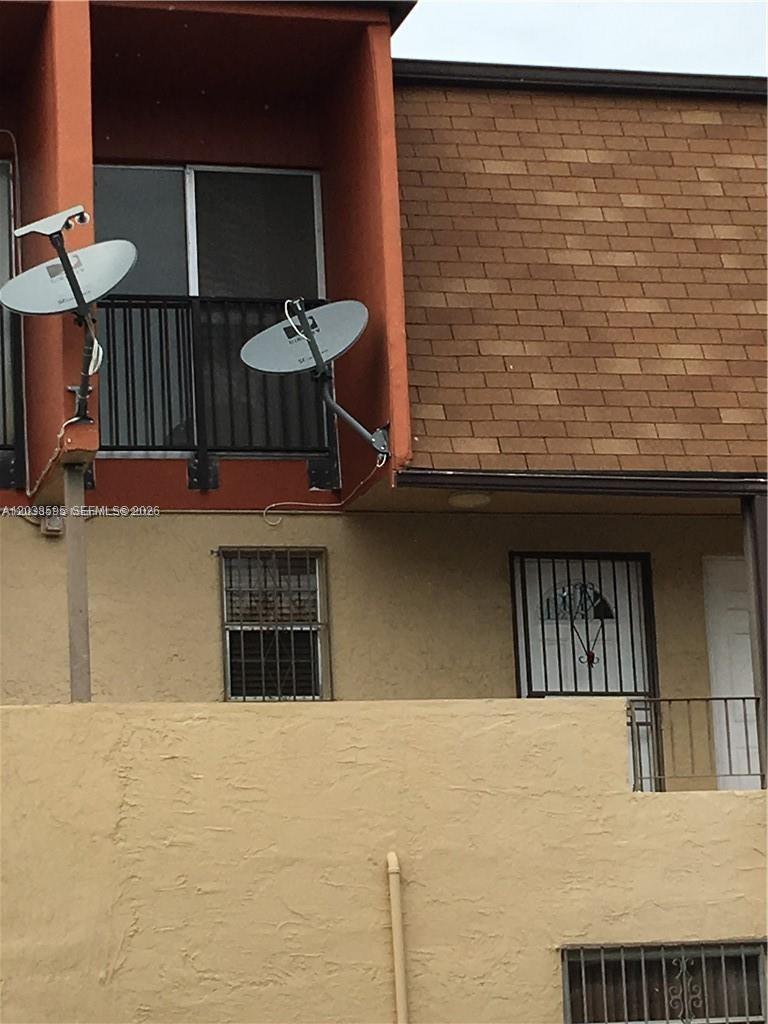 The exterior of a multi-story building features two satellite dishes and a brick facade — 315 NW 109th Ave # 207, Miami FL 33172, MIAMI, FL