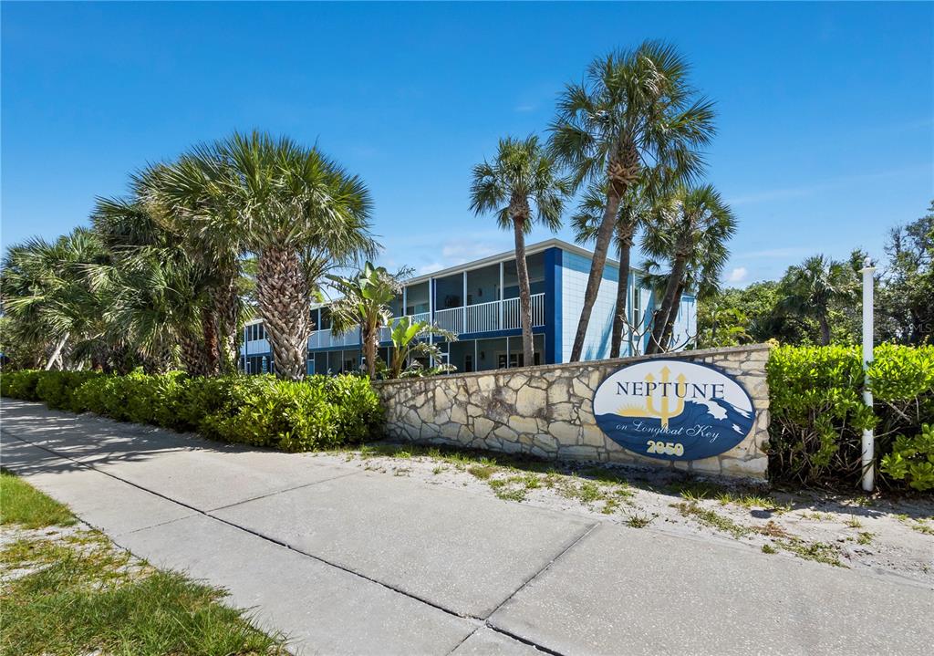 A kitchen features white cabinets, granite countertops, stainless steel appliances, and a subway tile backsplash — 2850 GULF OF MEXICO DRIVE UNIT 5, LONGBOAT KEY, FL