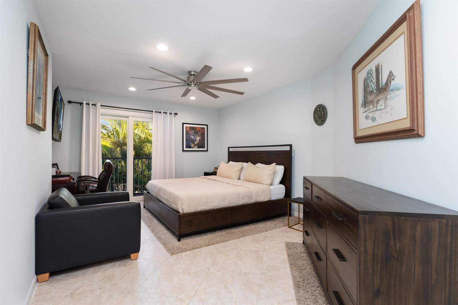 A bedroom features a dark wood bed, a matching dresser, and a sliding glass door — 961 S Ocean Drive # 302, Deerfield Beach FL 33441, DEERFIELD BEACH, FL