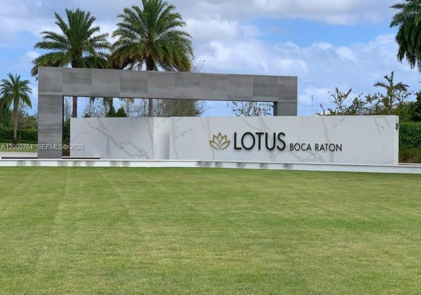 A large, modern monument sign for Lotus Boca Raton stands on a manicured green lawn — 17041 Teton River Rd, Boca Raton FL 33496, BOCA RATON, FL