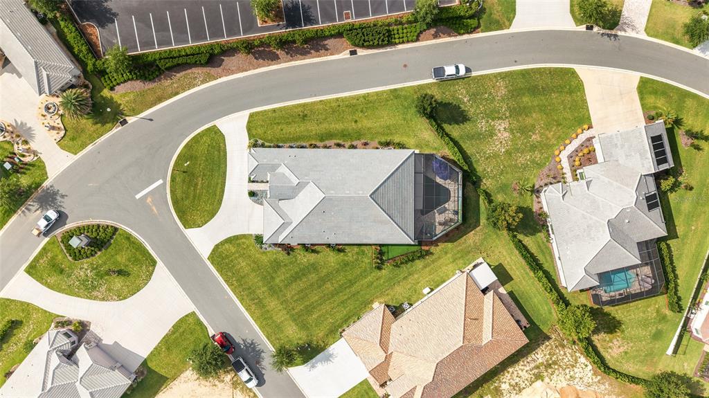 An aerial view shows several suburban houses with gray roofs, driveways, and green lawns — 1500 W ALTON BAY PLACE, HERNANDO, FL