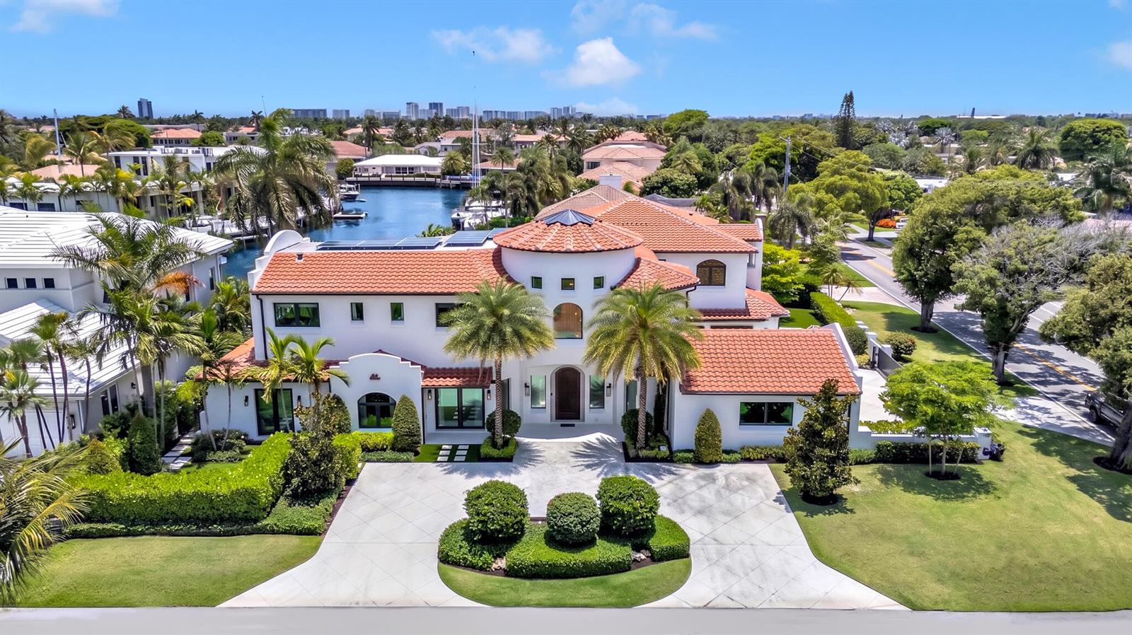 An aerial view of a two-story Mediterranean-style house with a red tile roof and driveway — 2300 NE 34th Court, Lighthouse Point FL 33064, LIGHTHOUSE POINT, FL