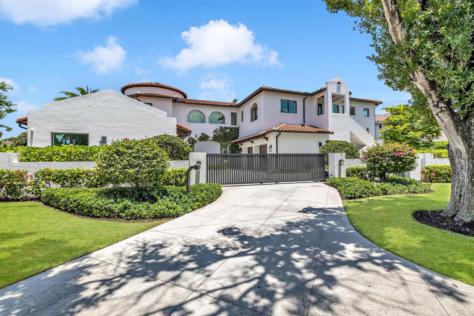 A white two-story house with a tiled roof and a gated driveway entrance — 2300 NE 34th Court, Lighthouse Point FL 33064, LIGHTHOUSE POINT, FL