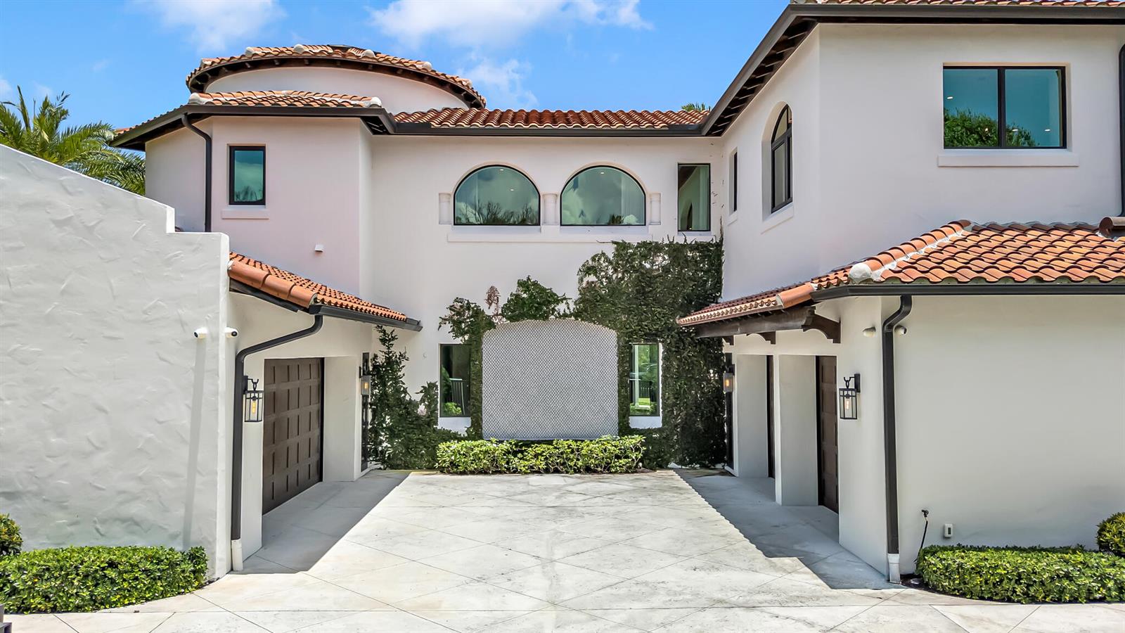 A white stucco house with a tiled roof features a courtyard and two garages — 2300 NE 34th Court, Lighthouse Point FL 33064, LIGHTHOUSE POINT, FL