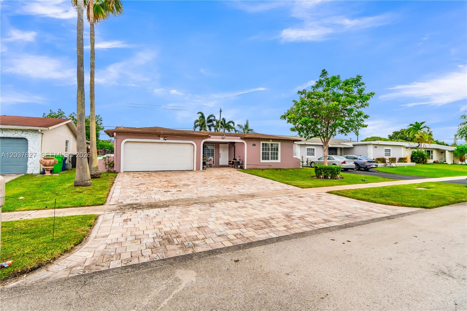 A single-story house with a paved driveway, a garage, and a pink exterior — 2751 NW 107th Ter, Sunrise FL 33322, SUNRISE, FL