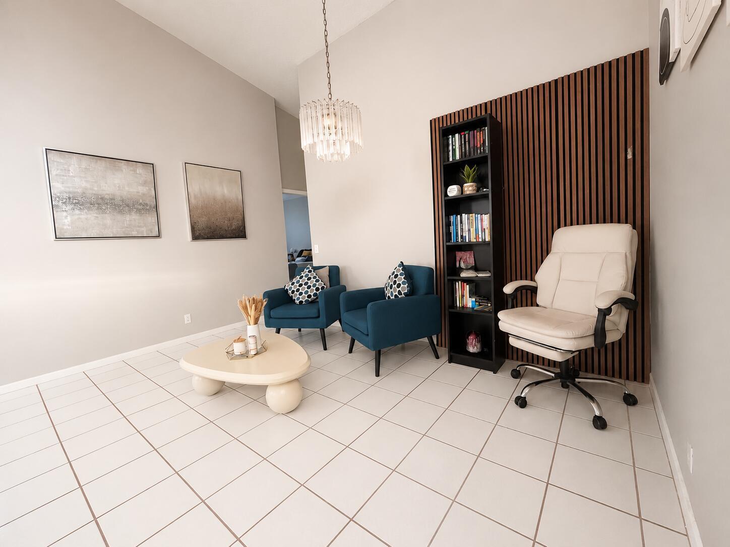 A living area features blue armchairs, a coffee table, a bookshelf, and a white chair — 3071 Dogwood Lane, Margate FL 33063, MARGATE, FL