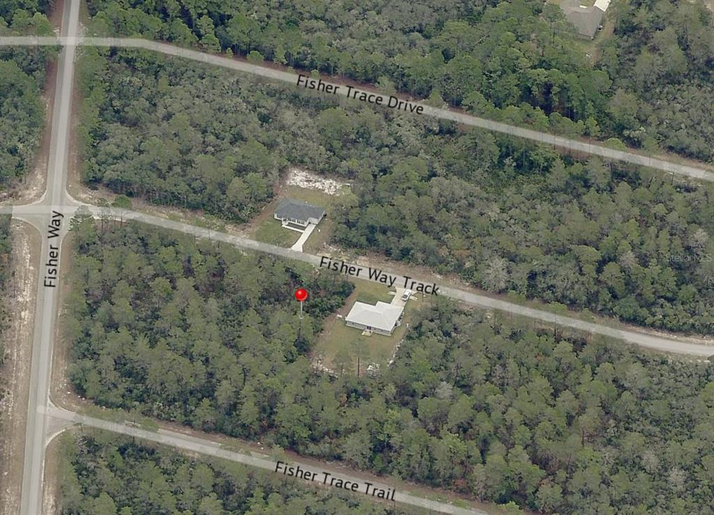 This aerial map shows two houses situated on a wooded lot near several roads — Lot 22 FISHER WAY TRACK, OCKLAWAHA, FL