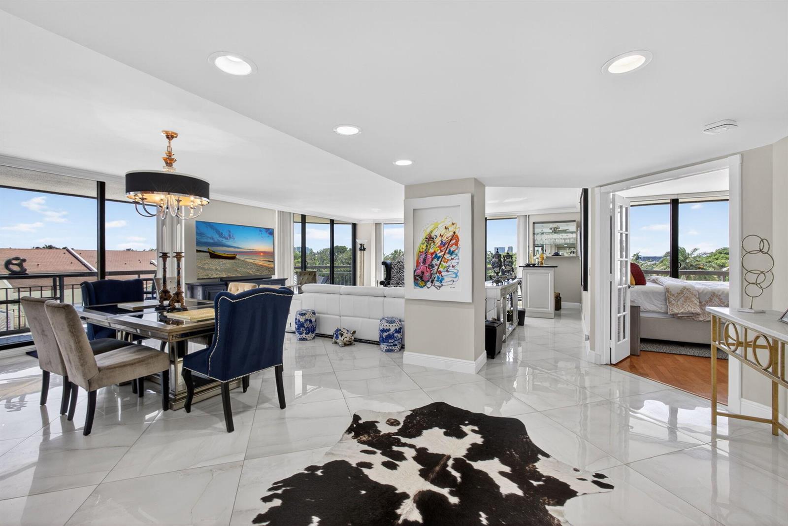 A bright open-concept living and dining area features white tile floors and floor-to-ceiling windows — 4100 N Ocean Drive # 304, Riviera Beach FL 33404, RIVIERA BEACH, FL