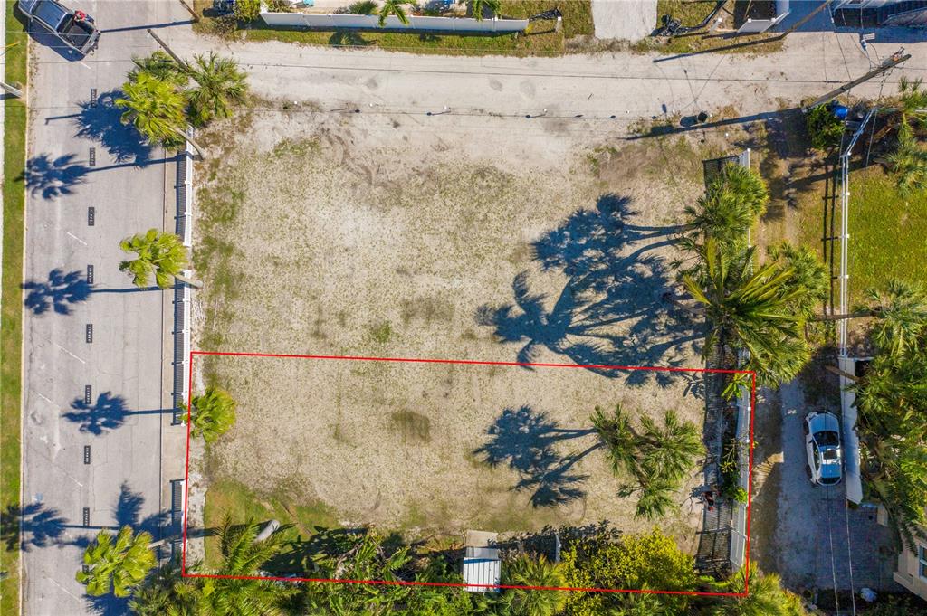 An aerial view of a rectangular, vacant grass lot outlined in red — 15TH AVENUE, ST PETE BEACH, FL