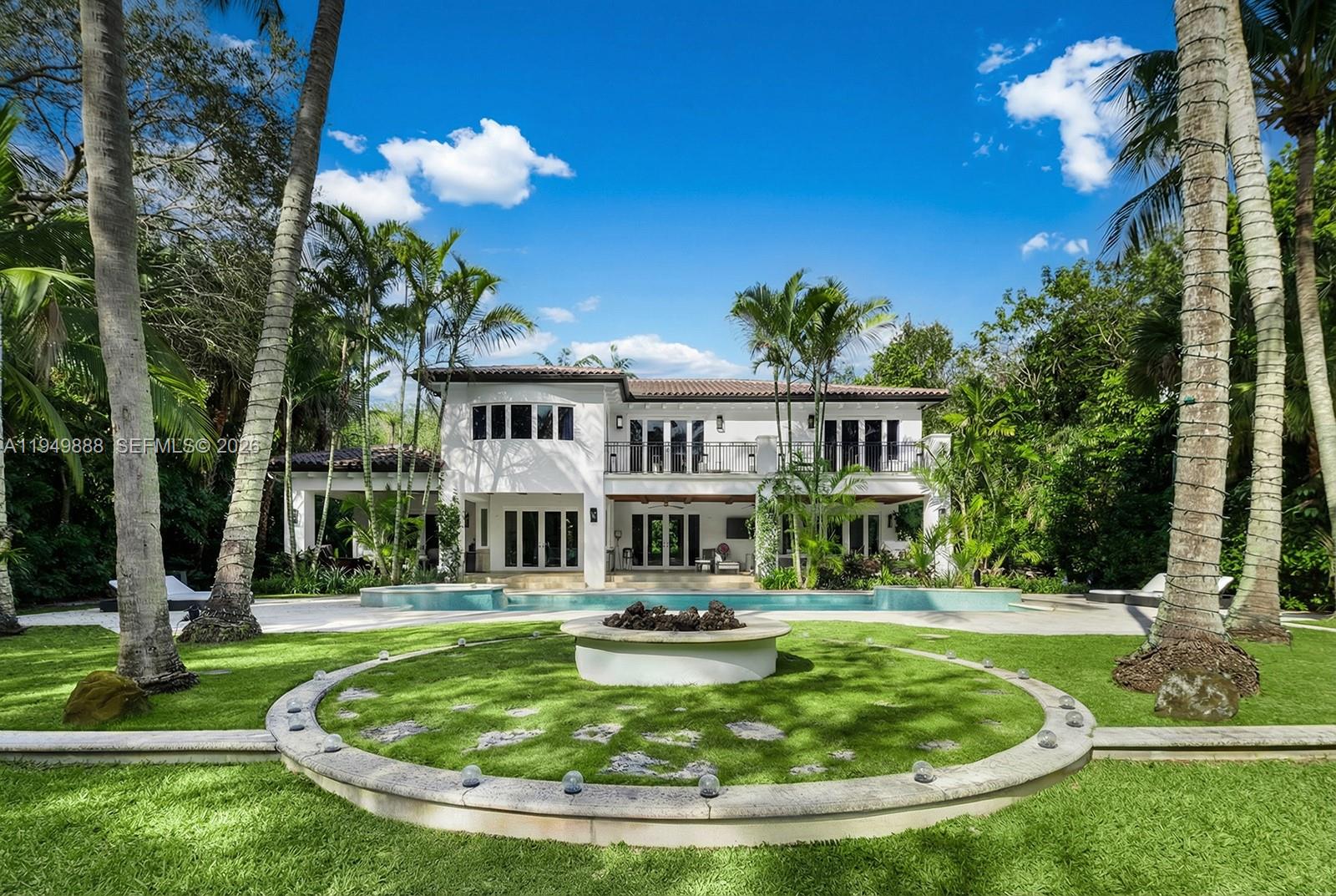 A two-story white house features a swimming pool and a circular fire pit area — 5002 SW 86th St, Miami FL 33143, MIAMI, FL