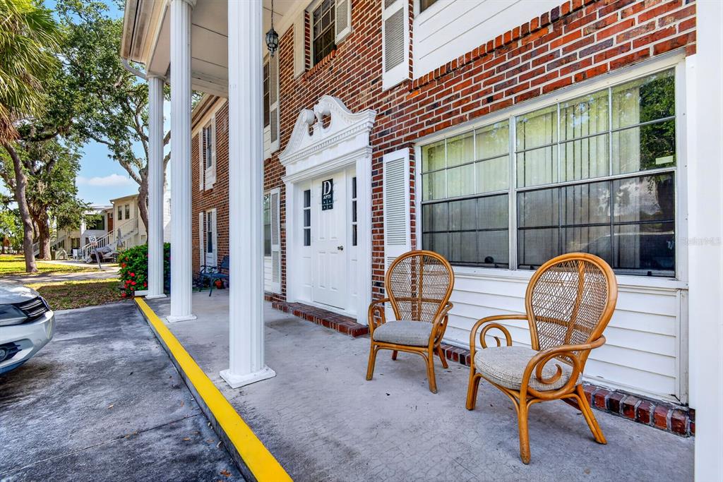 An empty room with light-colored walls, wood-look flooring, a window, and a white door — 4507 9TH STREET W UNIT D6, BRADENTON, FL