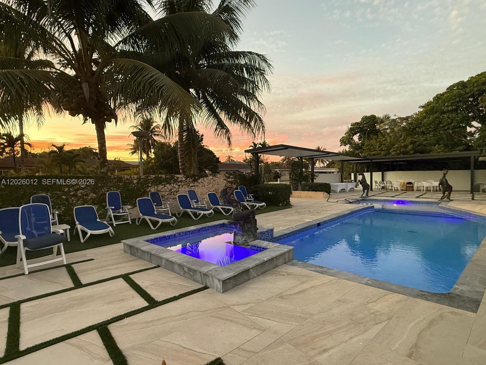 A swimming pool with a small fountain sits on a patio with lounge chairs — 5540 SW 63rd Ct # 0, Miami FL 33155, MIAMI, FL