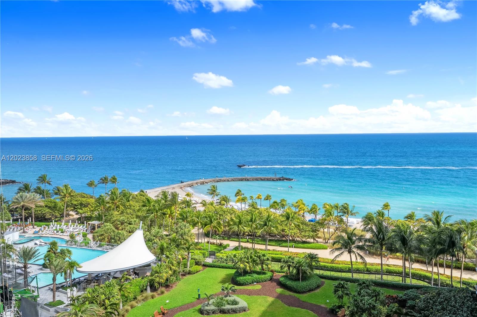 An elevated view shows a tropical resort with a swimming pool, gardens, and ocean beach — 10275 Collins Ave # 1035, Bal Harbour FL 33154, BAL HARBOUR, FL