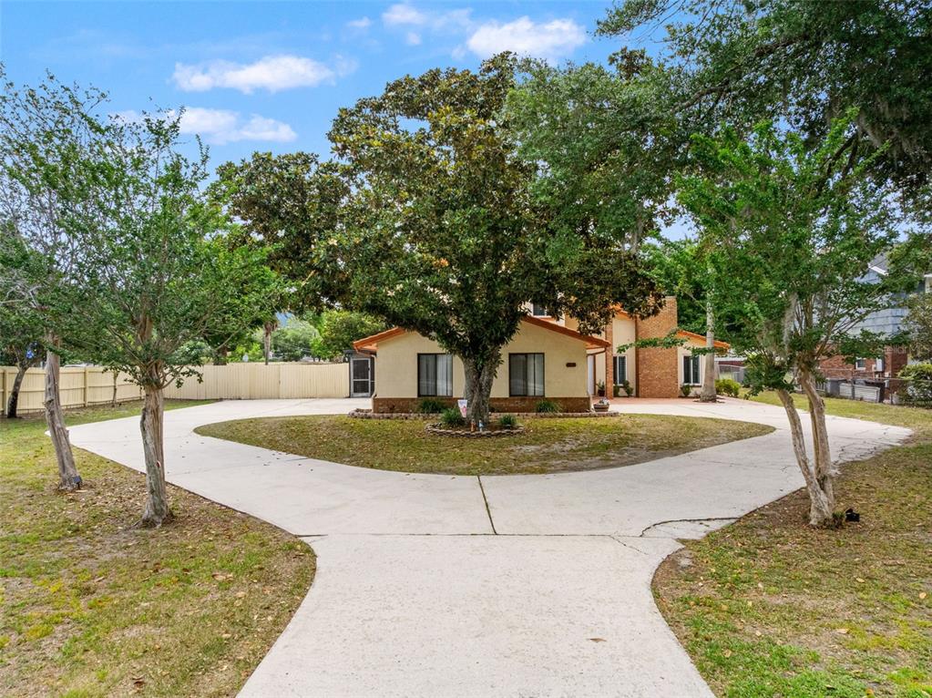 A single-story house with a circular driveway and a large tree in the front yard — 1161 W LAKE BRANTLEY ROAD, ALTAMONTE SPRINGS, FL