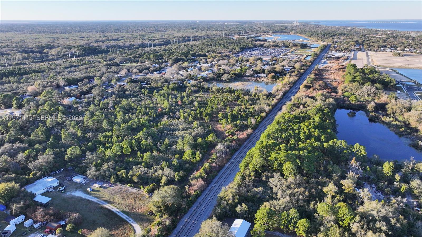 An aerial view shows a railroad track running through a wooded area with nearby ponds — not assigned, Cocoa FL 32754, COCOA, FL