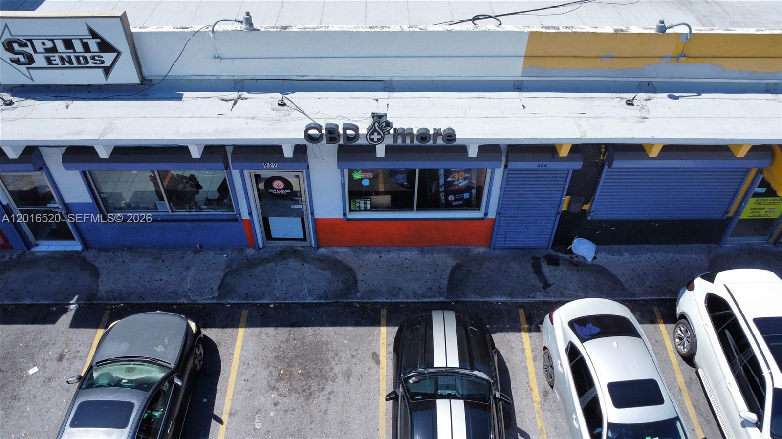 An aerial view shows a commercial storefront with a CBD shop and parking spaces — 922 NW 36th st, Miami FL 33127, MIAMI, FL