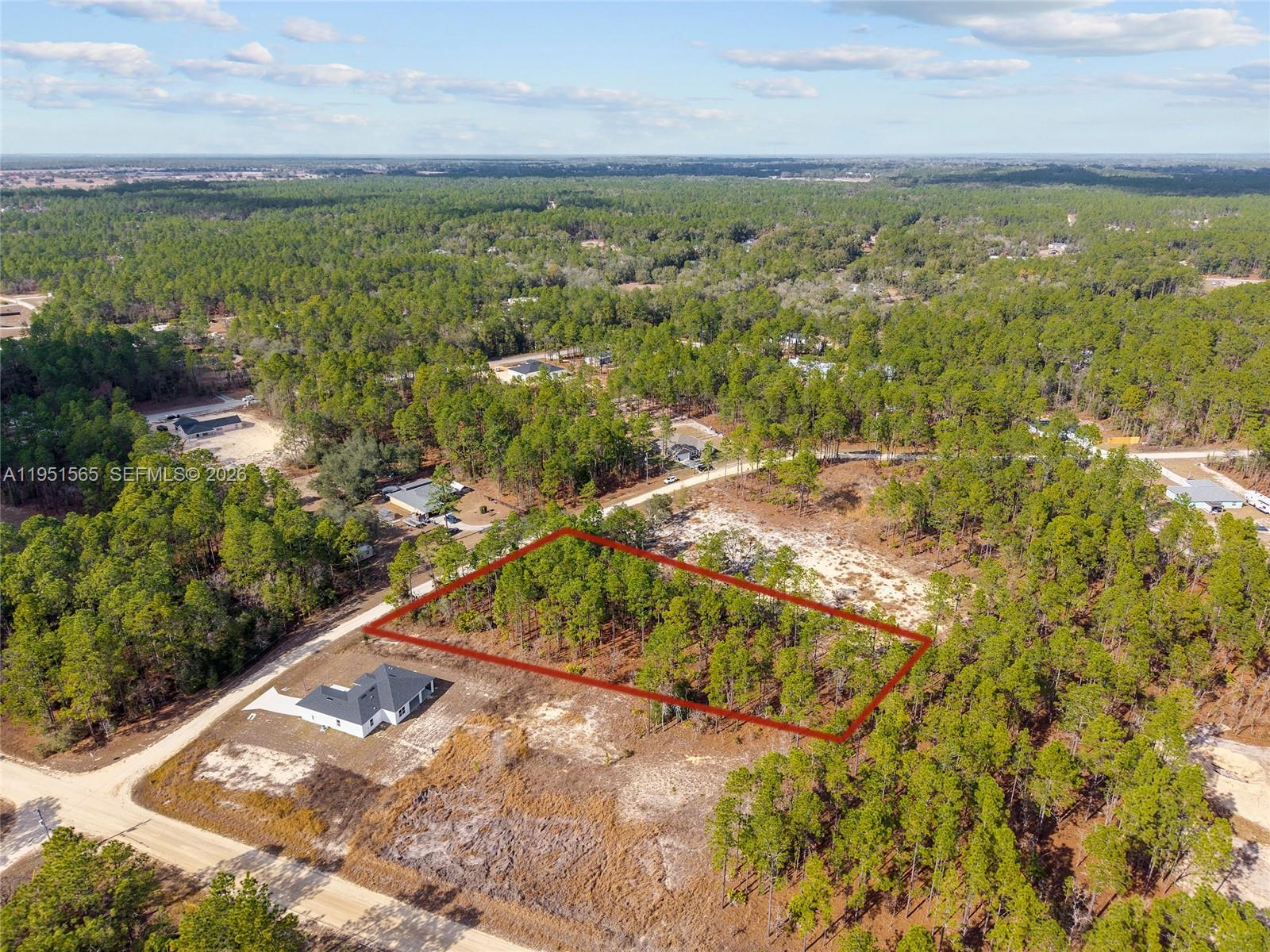 An aerial view shows a rectangular plot of land outlined in red near a house — TBD SW 128th Terrace Road, Ocala FL 34481, OCALA, FL