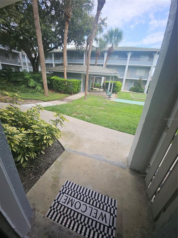 A view from a patio looking out toward a grassy courtyard and apartment buildings — 125 WATER FRONT WAY UNIT 130, ALTAMONTE SPRINGS, FL
