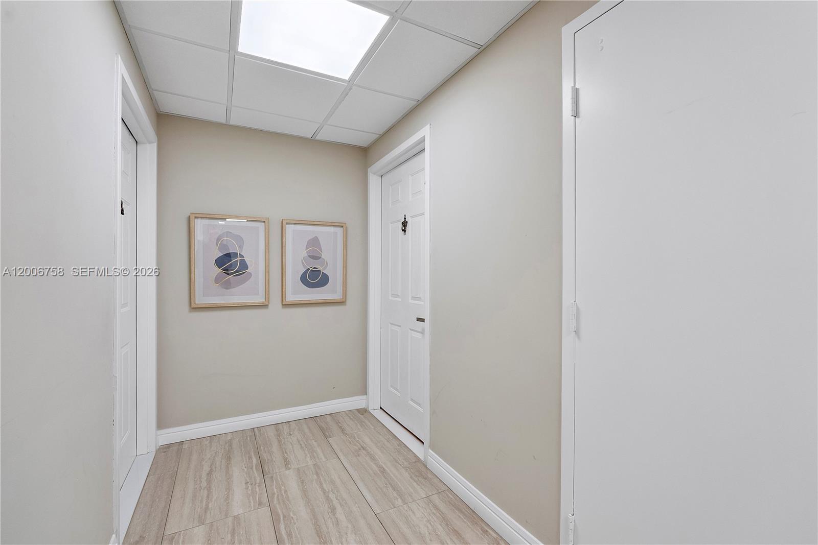 A dining area features a glass table, red chairs, and a built-in desk — 950 De Soto Rd # 3C, Boca Raton FL 33432, BOCA RATON, FL
