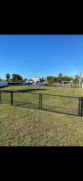 A view of a canal with several multi-story houses and a boat dock — 6525 JOSIE LANE, HUDSON, FL