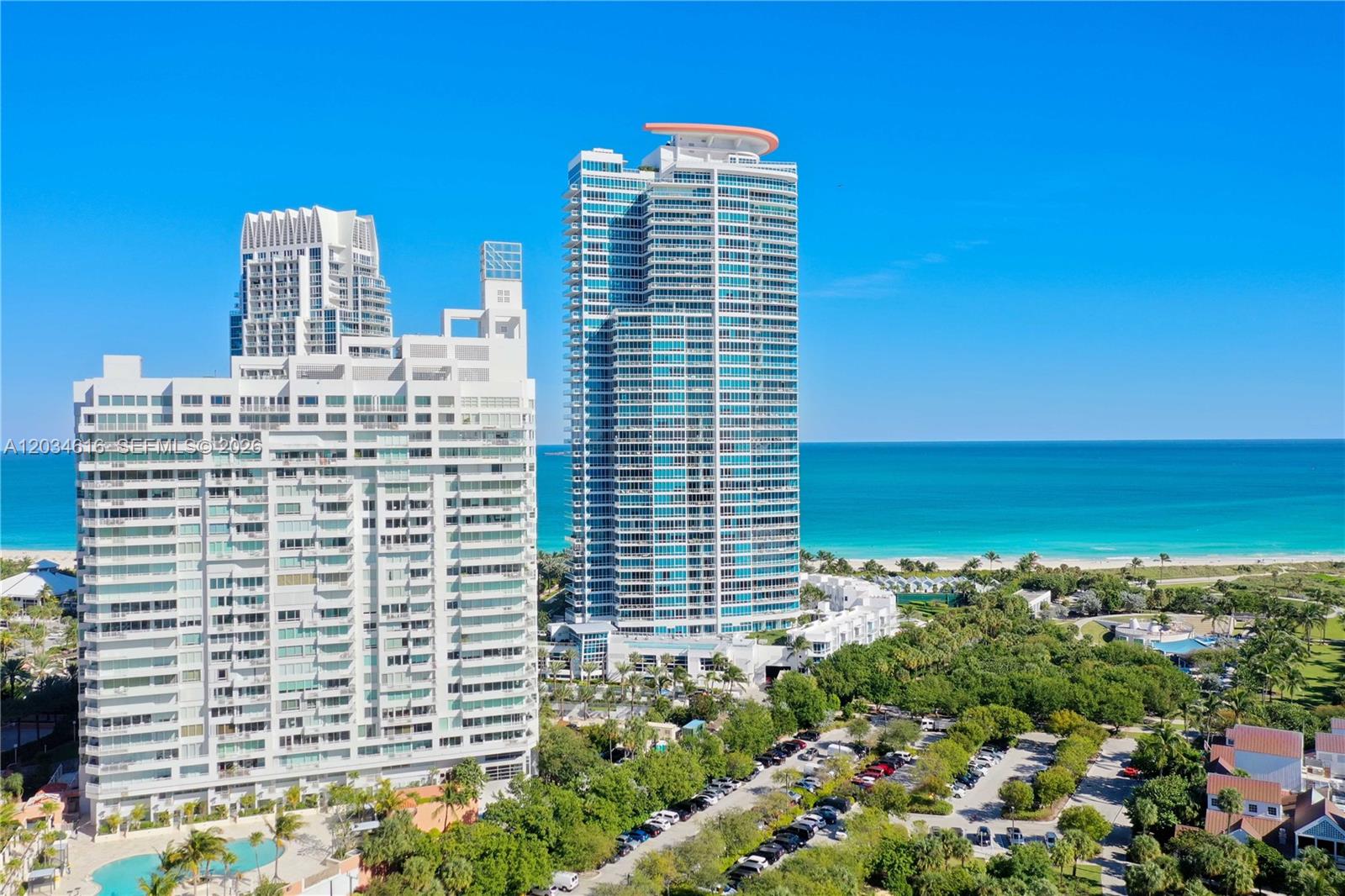 An aerial view shows two tall residential towers situated near a beach and ocean — 100 S Pointe Dr # 1608, Miami Beach FL 33139, MIAMI BEACH, FL