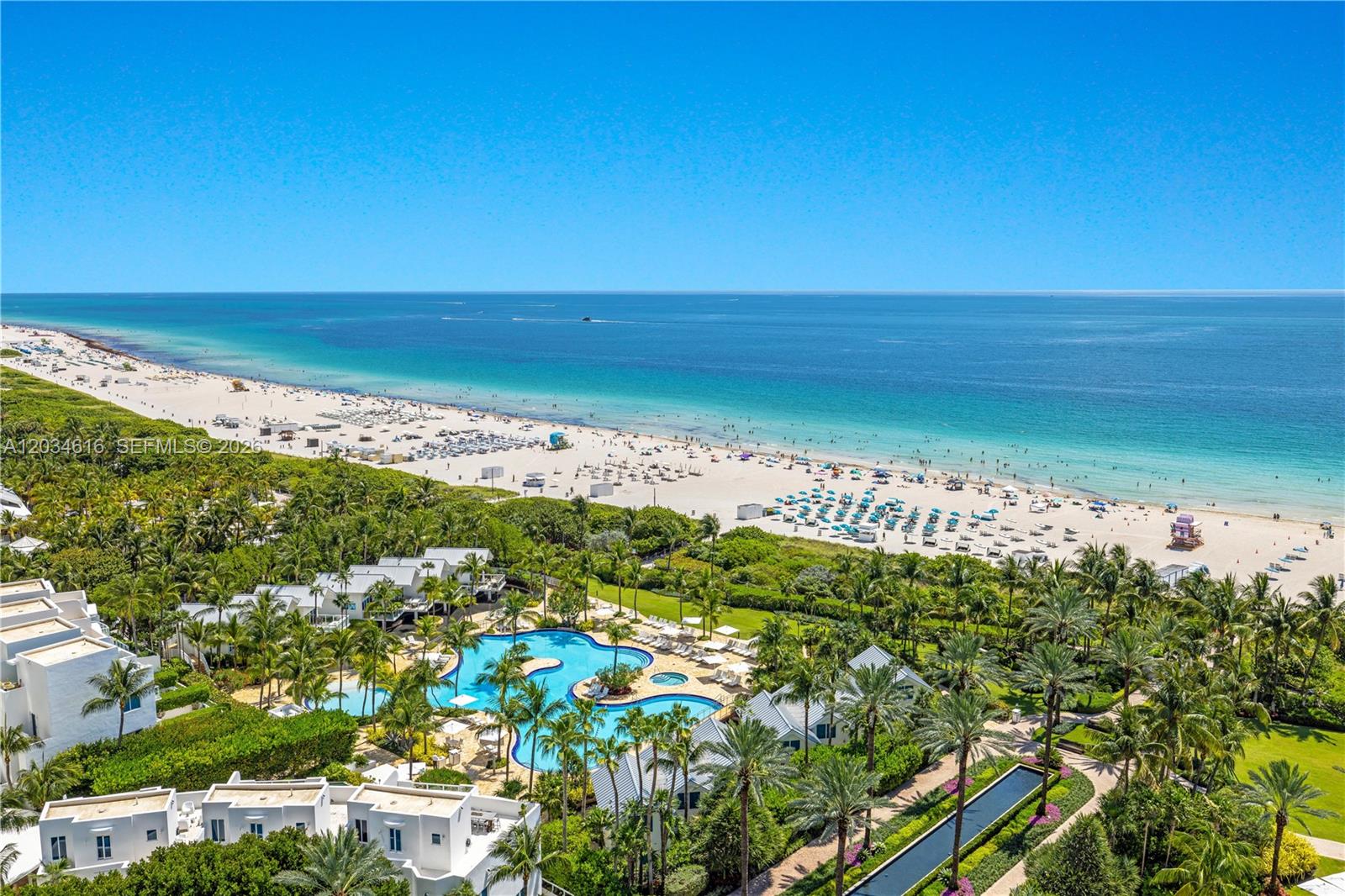 An aerial view shows a beach resort with a swimming pool and tropical landscaping — 100 S Pointe Dr # 1608, Miami Beach FL 33139, MIAMI BEACH, FL