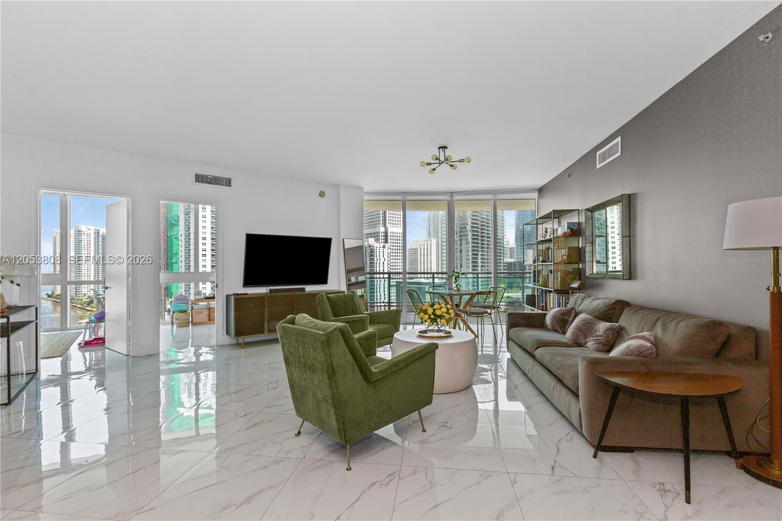 A living room features marble floors, a grey accent wall, and floor-to-ceiling windows with views — 350 S Miami Ave # 2102, Miami FL 33130, MIAMI, FL