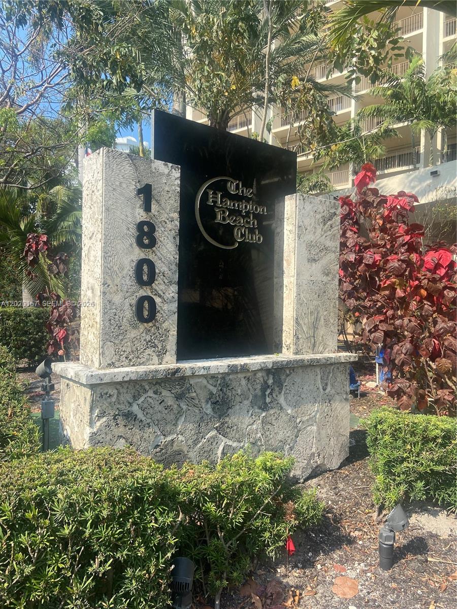 A stone monument sign displays the address 1800 and the name The Hampton Beach Club — LAUDERDALE BY THE SEA, FL