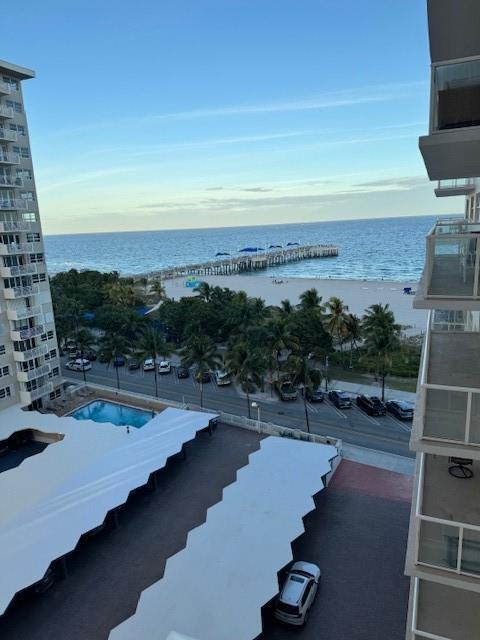 An elevated view of a beach, ocean pier, parking lot, and swimming pool from a balcony — 111 N Pompano Beach Boulevard # 1005, Pompano Beach FL 33062, POMPANO BEACH, FL